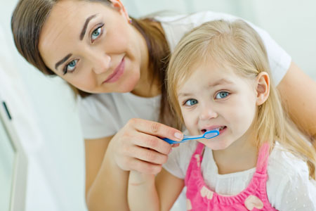 Mom and Daughter brushing their teeth - Pediatric Dentist in Chicago, IL